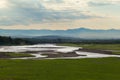 Valley view with river and mountains in the background at sunrise Royalty Free Stock Photo