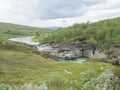 Valley with winding Laddejahka river, birch tree forest and green mountains. Lapland landscape Sweden at Padjelantaleden Royalty Free Stock Photo