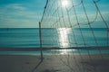 Valleyball net on the beach with beautiful seasacpe view and sunset light in twilight time at Chao Lao Beach. Royalty Free Stock Photo