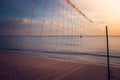 Valleyball net on the beach with beautiful seascape view and sunset light in twilight time at Chao Lao Beach. Royalty Free Stock Photo