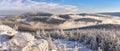 Through the valleys, the fog climbs the snow-capped mountain range of the Snieznik Massif just before sunset, the view from the