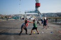 Men boxing at Muelle Baron pier with portal crane in background. Boxing training outdoors.