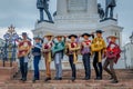 VALPARAISO, CHILE - SEPTEMBER, 15, 2018: Young tourists wearing hats and Chilean fabrics in front of a Monument To The