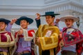 VALPARAISO, CHILE - SEPTEMBER, 15, 2018: Young tourists wearing hats and Chilean fabrics in front of a Monument To The