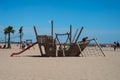 Children playing in a wooden game for children in shaped boat on the beach Royalty Free Stock Photo