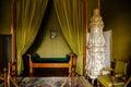 Valtice, Southern Moravia, Czech Republic, 04 July 2021: Castle interior with baroque wooden carved furniture, bedroom with green Royalty Free Stock Photo