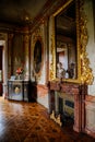 Valtice, Southern Moravia, Czech Republic, 04 July 2021: Castle interior with baroque wooden carved furniture, large tall mirror