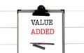 VALUE ADDE text on clipboard on white background Royalty Free Stock Photo