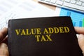 Value added tax VAT written on a book.