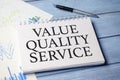 value quality service word on notepad and charts Royalty Free Stock Photo