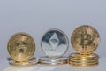 Valueable crypto coins bitcoin ether and ada in a row with gray background close up