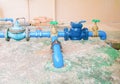 Valves water brass with knob green at connection joint old pipe steel paint blue. on the cement floor outside of the Industrial bu Royalty Free Stock Photo