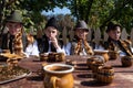 Vama, Romania, September 28th, 2019, Portraiture of young men wearing traditional sitting at table outdoor in Bucovina