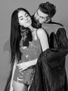 Vampire bites female neck. Couple in love play role game. Vampires victim concept. Man and woman dressed like vampire Royalty Free Stock Photo