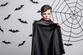 Vampire Halloween Concept - Portrait of handsome caucasian Vampire halloween costume fluttering his red, black cloak. Royalty Free Stock Photo