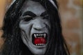 Vampire mask with fangs and long black hair close up Royalty Free Stock Photo