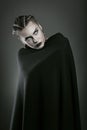 Vampire wrapped in black cloak Royalty Free Stock Photo