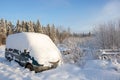 The van of the car covered with a deep cover of white snow, with a copy of the space