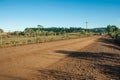 Van in a dirt road passing through rural lowlands