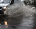 Van driving through Flooded road splashing sidewalk / pavements