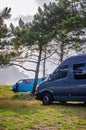 Van on the grass parking lot close to the beach. Campervan parking. Royalty Free Stock Photo