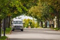 Van Lifestyle concept. Van parked in a street between trees in Autumn. Gananoque, Canada Royalty Free Stock Photo