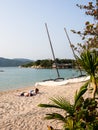 Vacationers relaxing on a sandy beach at Whale Island resort on a remote and isolated Whale