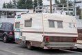 A mobile home is parked at the sidewalk near the homeless camp adjacent to 8100 Haskell Ave