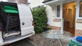 A van packed up with furniture chairs from a home move by the entrance