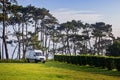 Van on the parking lot in the nature. Road trip concept. Campervan parking. Campsite. Royalty Free Stock Photo