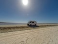 van on a straight gravel road between 2 salt lakes in the nullabor dessert of Australia, South Australia, Australia