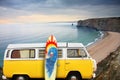 Van and surf board at a beach