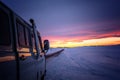 A van for traveling in the winter when the roads are covered with snow at dusk.