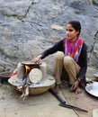 Lady preparing fresh baked chapati on an open fire