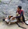 Lady preparing fresh baked chapati on an open fire