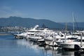 Vancouver, BC, Canada - August 16, 2023: A yachts and boats in the harbor of Vancouver with downtown in the background Royalty Free Stock Photo