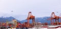 VANCOUVER, BC, CANADA - MAR 15, 2023: Cargo terminal loading shipping containers onto cargo ships, marine terminal Royalty Free Stock Photo