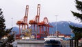 VANCOUVER, BC, CANADA - MAR 15, 2023: Cargo terminal loading shipping containers onto cargo ships, marine terminal Royalty Free Stock Photo