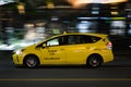 VANCOUVER, BC, CANADA - SEPT 21, 2019: A Vancouver yellow taxi speeding down West Georgia street on a busy Saturday