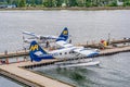 Vancouver, BC- July 17, 2022: Two Harbour Air seaplanes docked in Coal Harbour in Vancouver, British Col