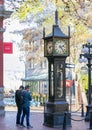 Vancouver BC. Tourists taking photos of the Gastown Steam Clock that every hour shows off whistling and shooting steam