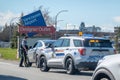 An RCMP or Royal Canadian Mounted Police officer stopping a civilian at the