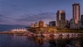 Sunset over the High Rise Buildings, Float Plane Terminal and Cruise Ship Terminal along the shore of Coal Harbor, Vancouver Royalty Free Stock Photo