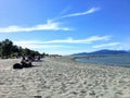 People enjoying the sun on a beautiful summer day along the beaches of Spanish Banks, in Vancouver, British Columbia, Canada.