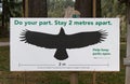 View of sign `Do your part. Stay 2 metres apart` in Capilano River Regional Park due to COVID-19coronavirus prevention