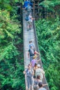 Vancouver, Canada - August 11, 2017: People at Capilano Bridge. It is a Suspension bridge crossing the Capilano River, 140 metres
