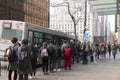 People lining up to board a Translink bus on West Georgia Street in Downtown Vancouver