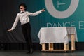 Dancer dressed as waiter performing on stage