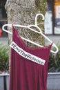 A red dress with text `End The Violence` is hanging on the tree near The Law Courts .
