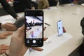 Woman is holding iPhone 11 Pro showing the amazing ultra wide angle camera at local Apple Store